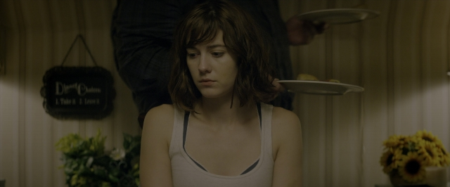 Wide shot frame from 10 Cloverfield Lane — standing, plate, room