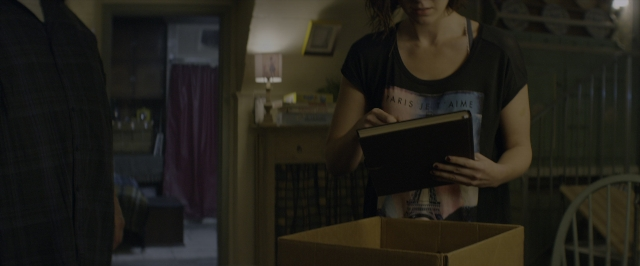 Wide shot frame from 10 Cloverfield Lane — book, standing, room