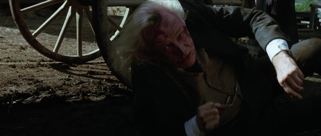 Wide shot frame from Unforgiven — face, wheel, person