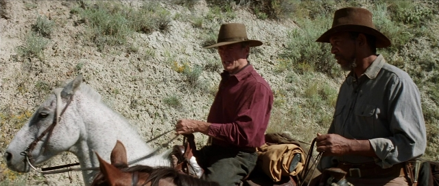 Wide shot frame from Unforgiven — standing, hat, shirt