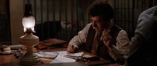 Wide shot frame from Unforgiven — sitting, book, table