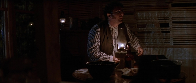 Wide shot frame from Unforgiven — sitting, plate, room
