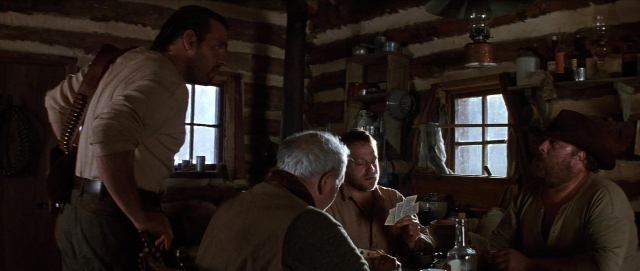 Wide shot frame from Unforgiven — sitting, standing, plate