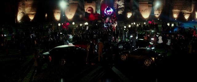 Wide shot frame from Zoolander 2 — standing, car, night