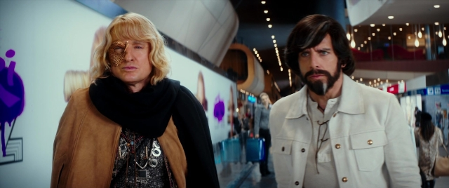 Wide shot frame from Zoolander 2 — walking, coat, beard