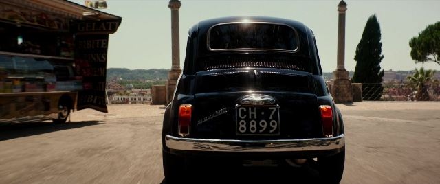 Wide shot frame from Zoolander 2 — plate, street, car