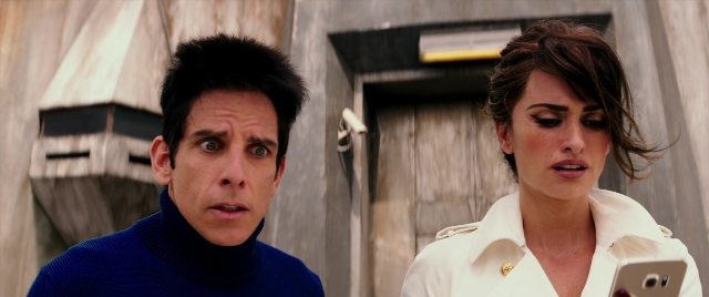 Medium shot frame from Zoolander 2 — standing, phone, door