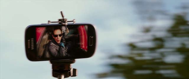 Wide shot frame from Zoolander 2 — phone, water, person