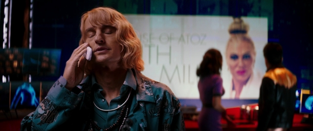 Medium shot frame from Zoolander 2 — standing, room, phone