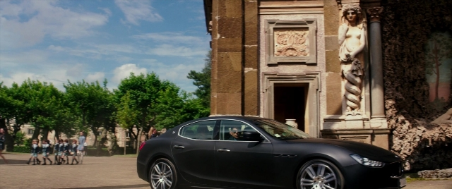Wide shot frame from Zoolander 2 — walking, street, car