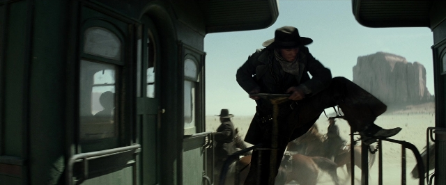 Wide shot frame from The Lone Ranger — sitting, hat, coat