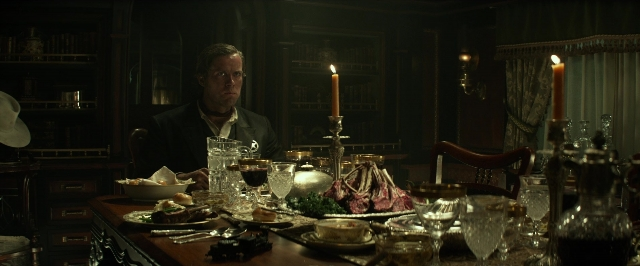 Wide shot frame from The Lone Ranger — sitting, room, table