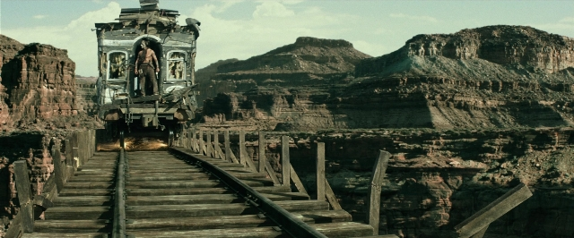 Wide shot frame from The Lone Ranger — standing, car, train