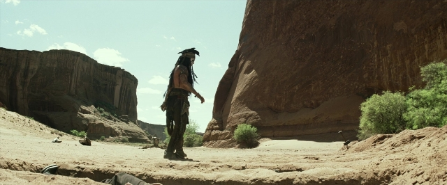 Medium shot frame from The Lone Ranger — standing, walking, hat