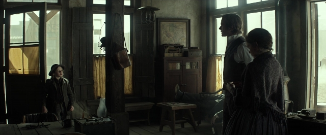 Wide shot frame from The Lone Ranger — book, standing, table