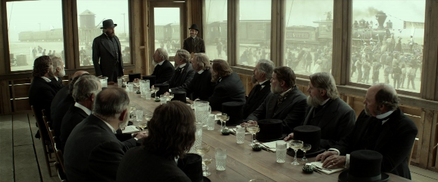 Wide shot frame from The Lone Ranger — sitting, standing, room