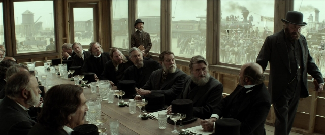 Wide shot frame from The Lone Ranger — sitting, standing, room