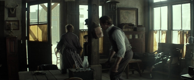Wide shot frame from The Lone Ranger — sitting, book, standing