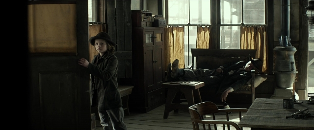Wide shot frame from The Lone Ranger — standing, room, table