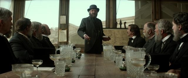 Wide shot frame from The Lone Ranger — sitting, book, room