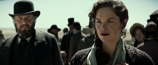 Medium shot frame from The Lone Ranger — standing, hat, coat