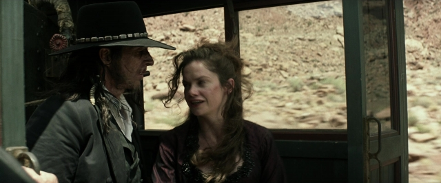 Wide shot frame from The Lone Ranger — sitting, hat, car