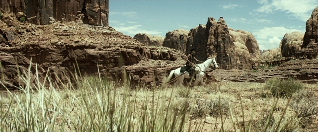 Wide shot frame from The Lone Ranger — hat, coat, horse