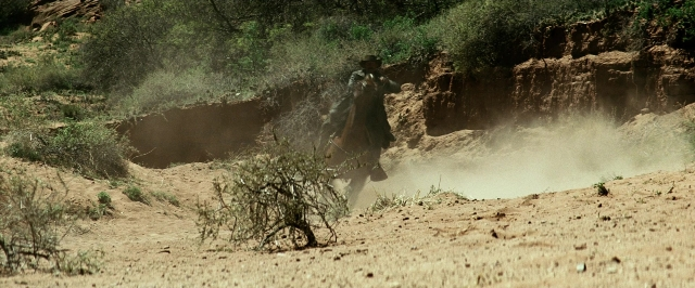 Wide shot frame from The Lone Ranger — hat, coat, hand