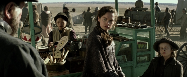 Wide shot frame from The Lone Ranger — sitting, standing, table