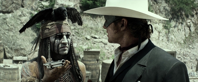 Wide shot frame from The Lone Ranger — standing, hat, hand