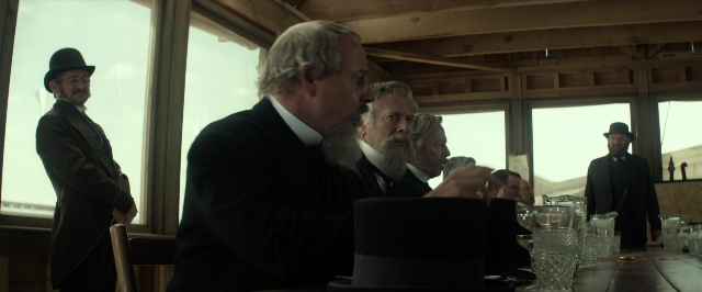 Wide shot frame from The Lone Ranger — sitting, standing, room