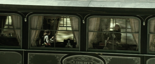Wide shot frame from The Lone Ranger — sitting, room, table