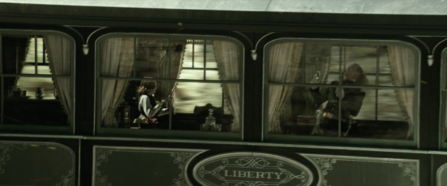 Wide shot frame from The Lone Ranger — sitting, book, table
