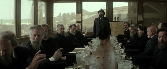 Wide shot frame from The Lone Ranger — sitting, standing, room