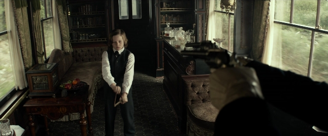 Wide shot frame from The Lone Ranger — standing, room, table