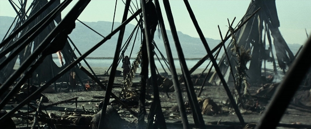 Wide shot frame from The Lone Ranger — fire, car
