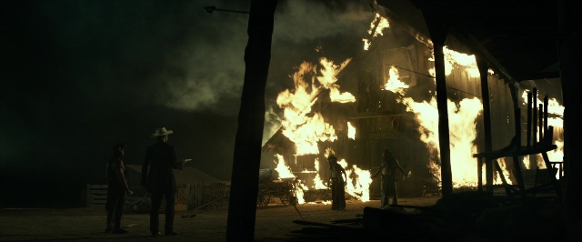 Wide shot frame from The Lone Ranger — standing, fire, smoke