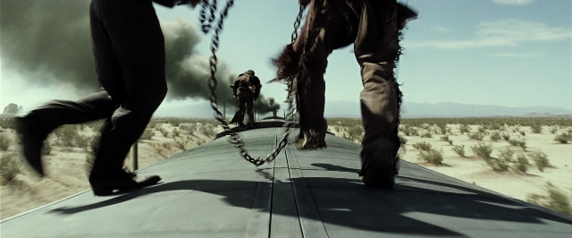 Wide shot frame from The Lone Ranger — standing, smoke, person