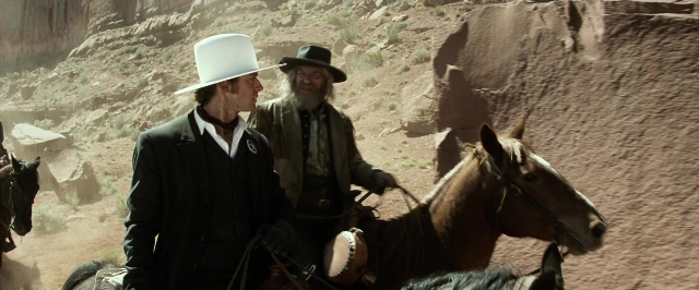 Wide shot frame from The Lone Ranger — sitting, standing, dialogue