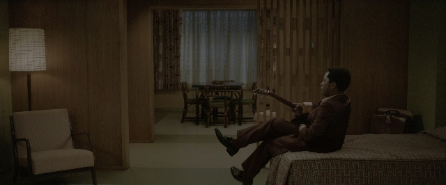 Wide shot frame from One Night in Miami — sitting, room, table