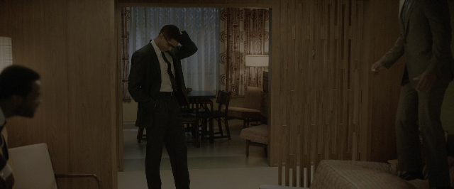 Wide shot frame from One Night in Miami — standing, room, table
