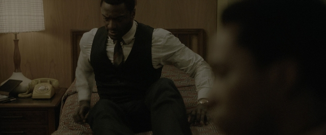 Wide shot frame from One Night in Miami — sitting, room, table