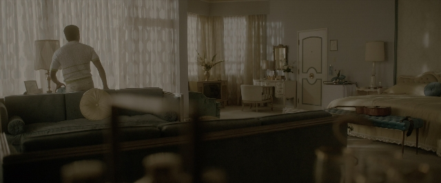 Wide shot frame from One Night in Miami — table, bed, mirror