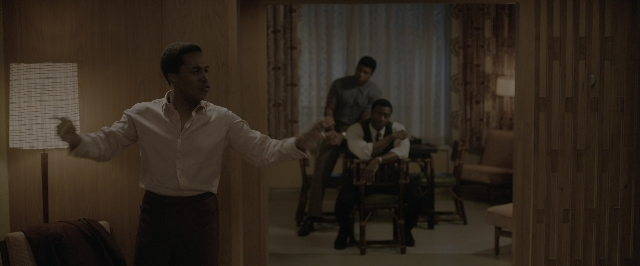 Wide shot frame from One Night in Miami — sitting, standing, room