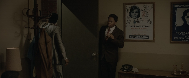 Wide shot frame from One Night in Miami — standing, room, table