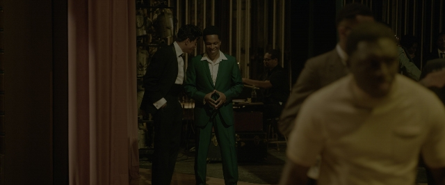 Wide shot frame from One Night in Miami — standing, room, table