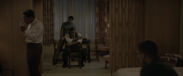 Wide shot frame from One Night in Miami — sitting, standing, room
