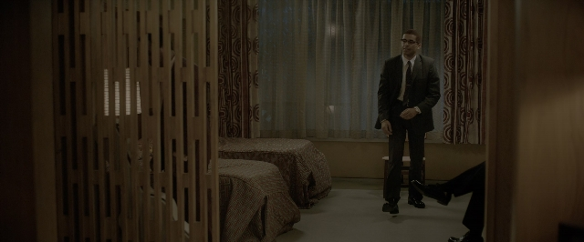 Wide shot frame from One Night in Miami — standing, room, bed