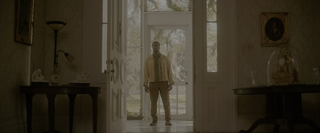 Wide shot frame from One Night in Miami — standing, room, table