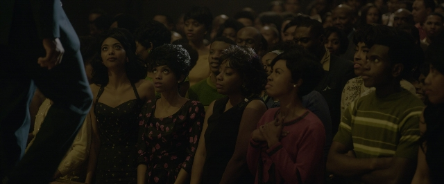 Wide shot frame from One Night in Miami — standing, room, hand